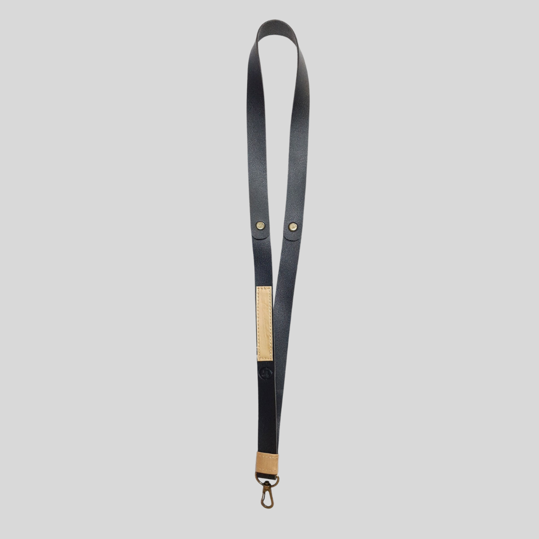A black leather ID lanyard with a wood-colored vegan leather strip for a touch of color.