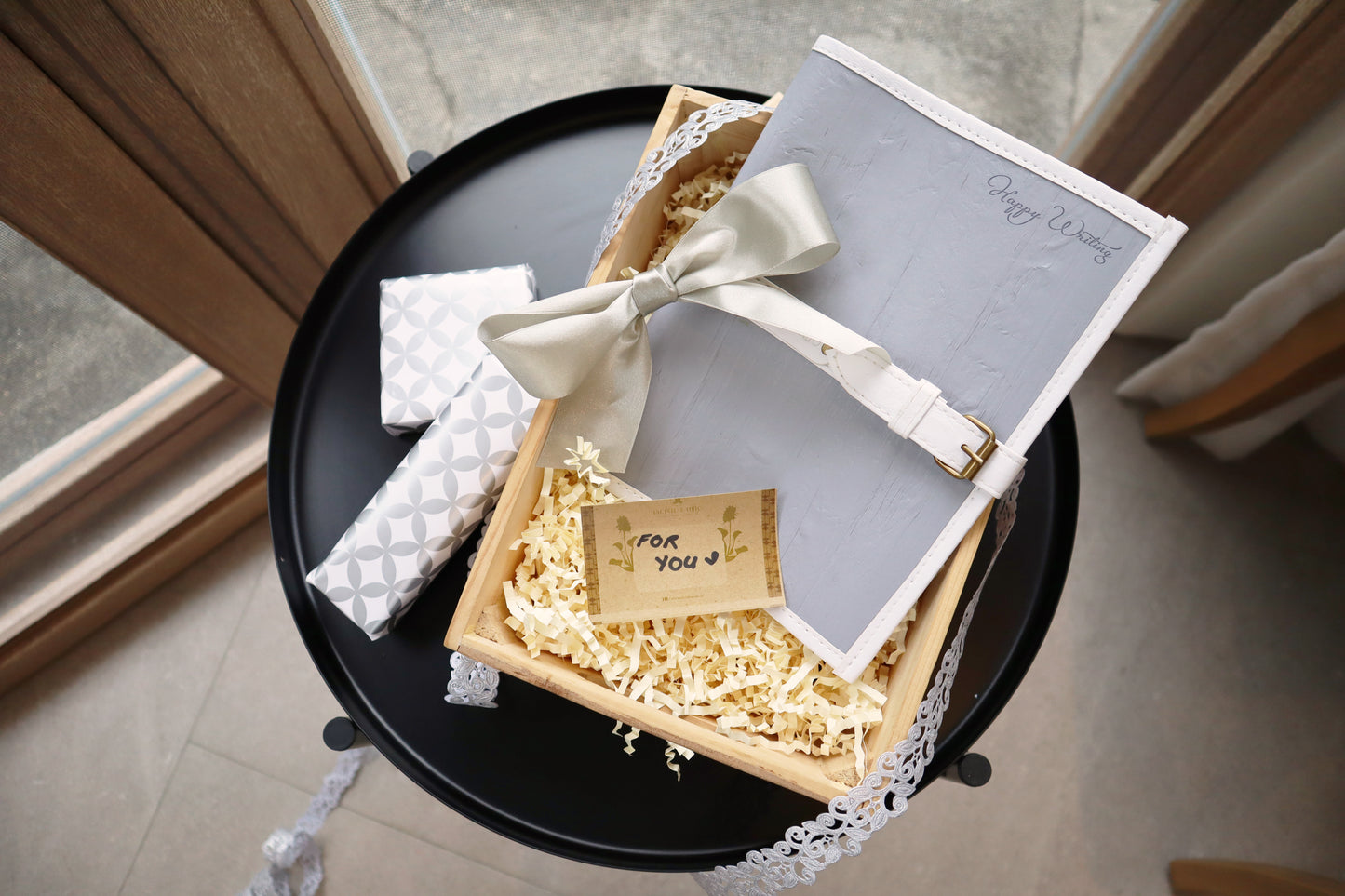 A white and gray journal wrapped in gift package.