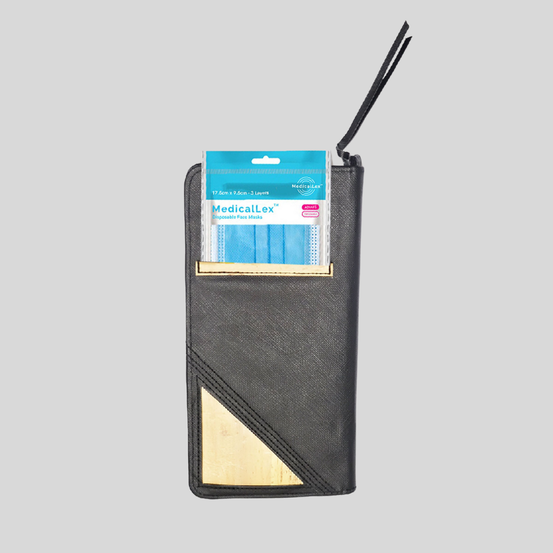 A black vegan leather wallet that has a packet of surgical masks tucked into its small back pocket.