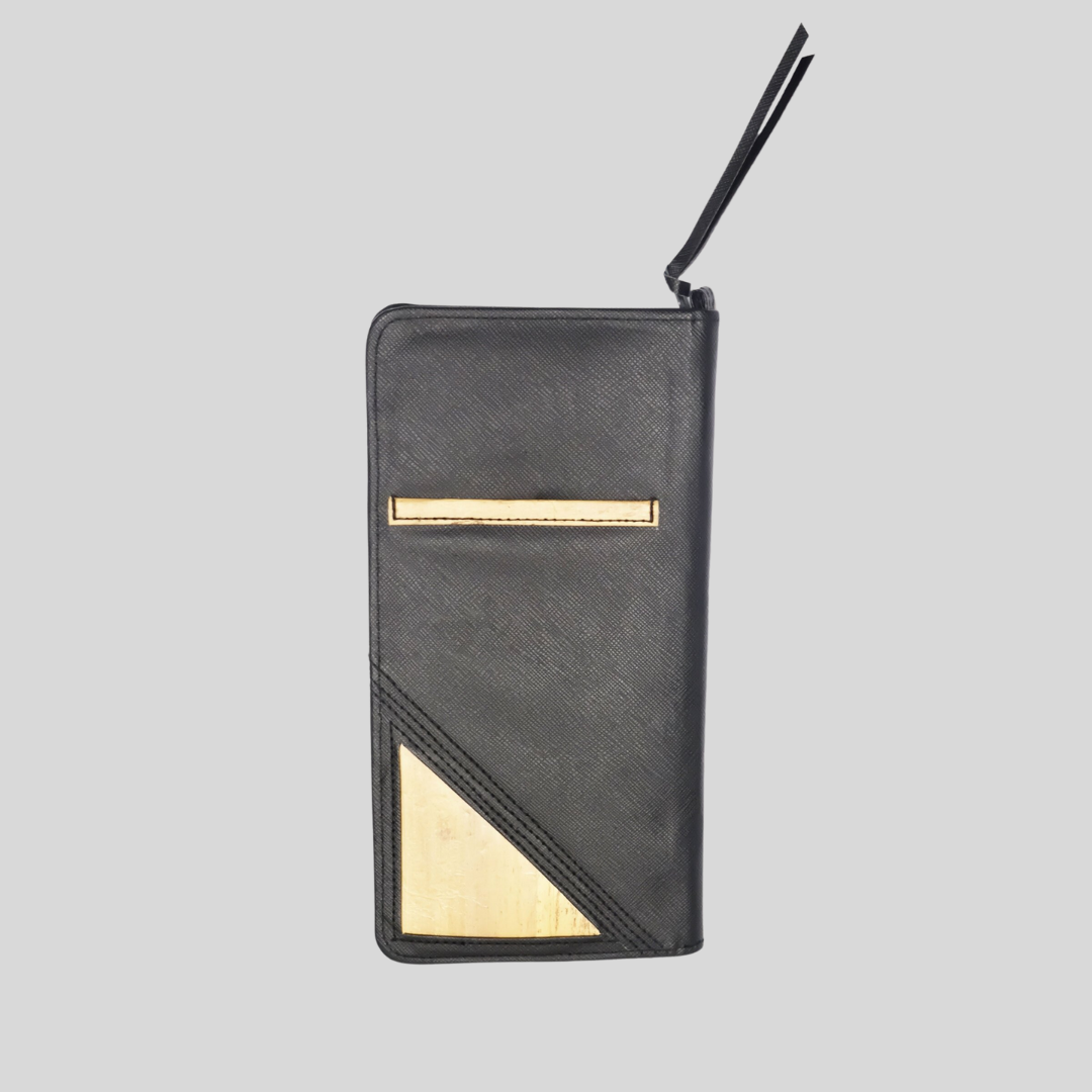 The backside of a black vegan leather wallet, that has water hyacinth vegan leather accents.