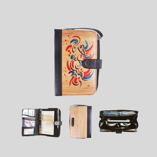 A vegan leather notebook with a black leather spine and magnetic snap closure also has a metal spine for refillable pages, and multiple built-in compartments within the journal. It even has a built-in wallet that can store a phone.
