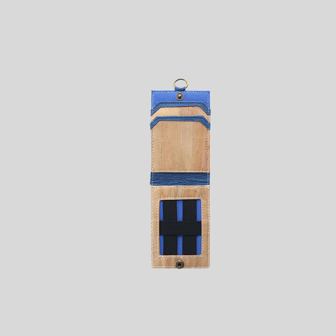 A hidden inner pocket inside of a pale blue and brown vegan leather ID case.