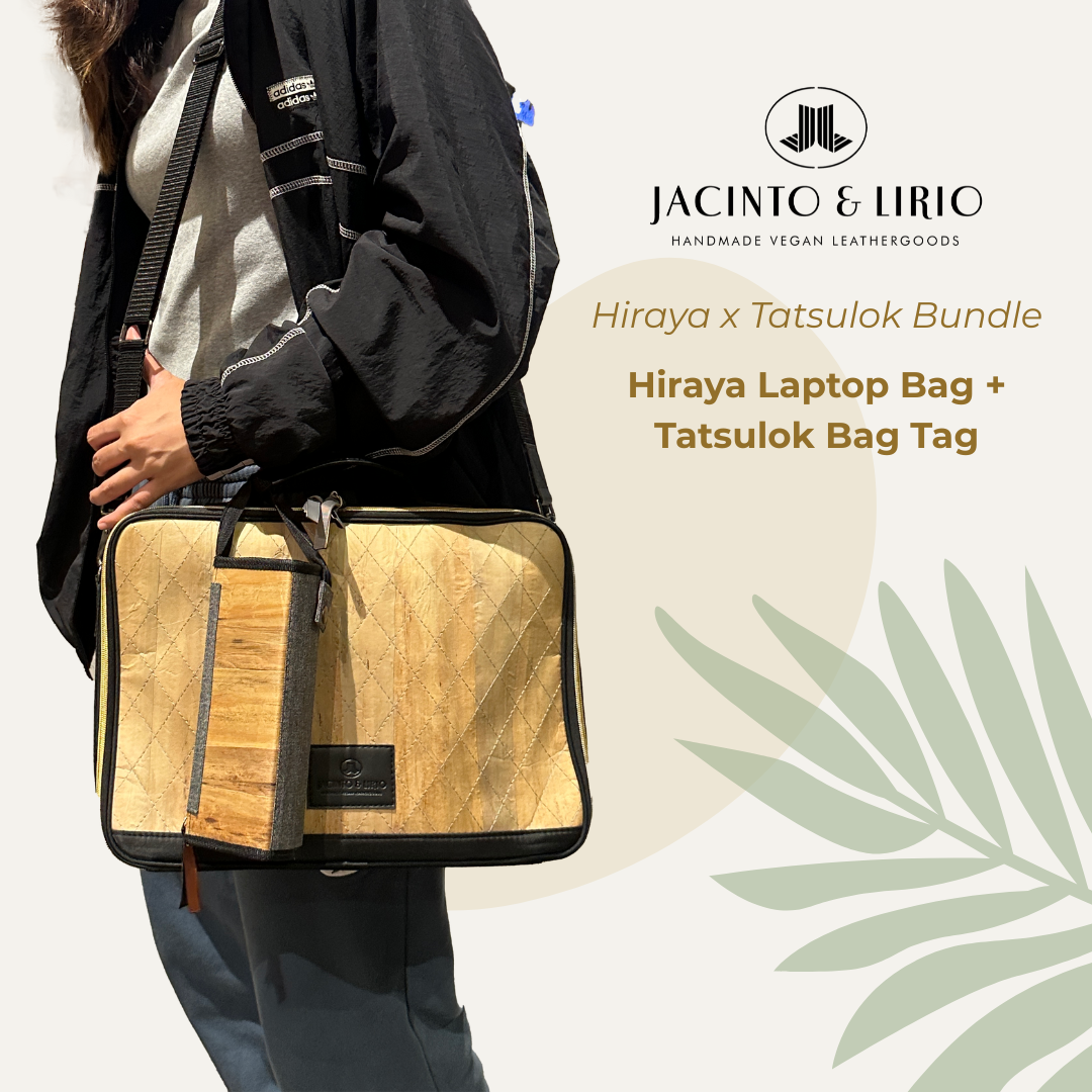 A Tatsulok vegan leather bag tag in ash-grey plain hanging on a 13" Hiraya laptop bag in black.