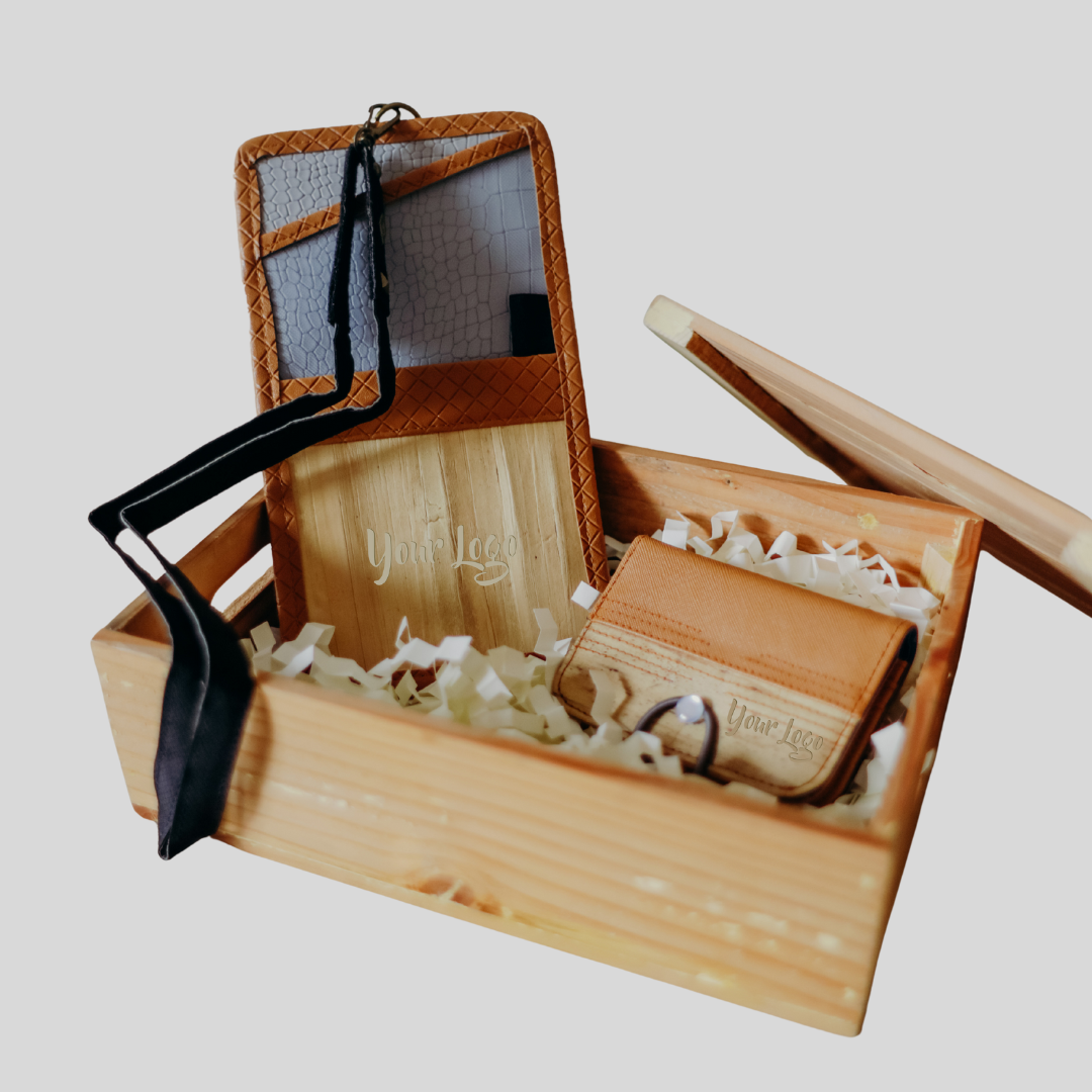 Vegan leather goods inside a wooden crate, namely a documents and papers holder and a card wallet, both in a brown monotone color scheme.