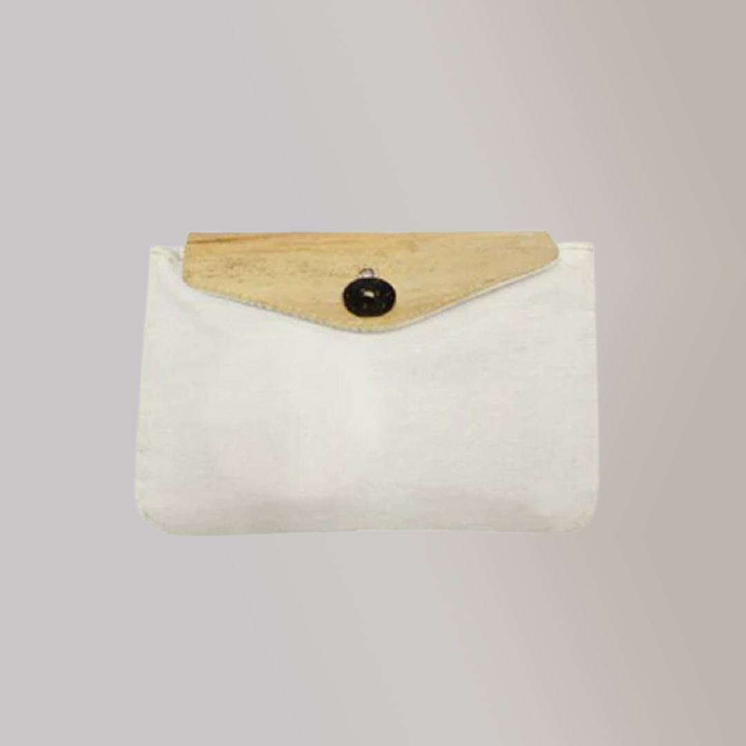 A white Cosmetics Pouch made out of canvas material and water hyacinth vegan leather on its front flap.