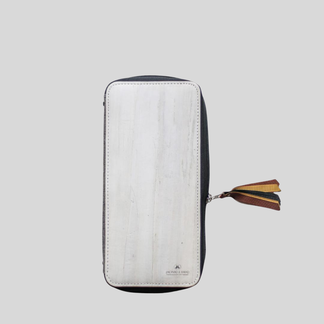 A half-zipped vegan leather wallet with a leather tassel.