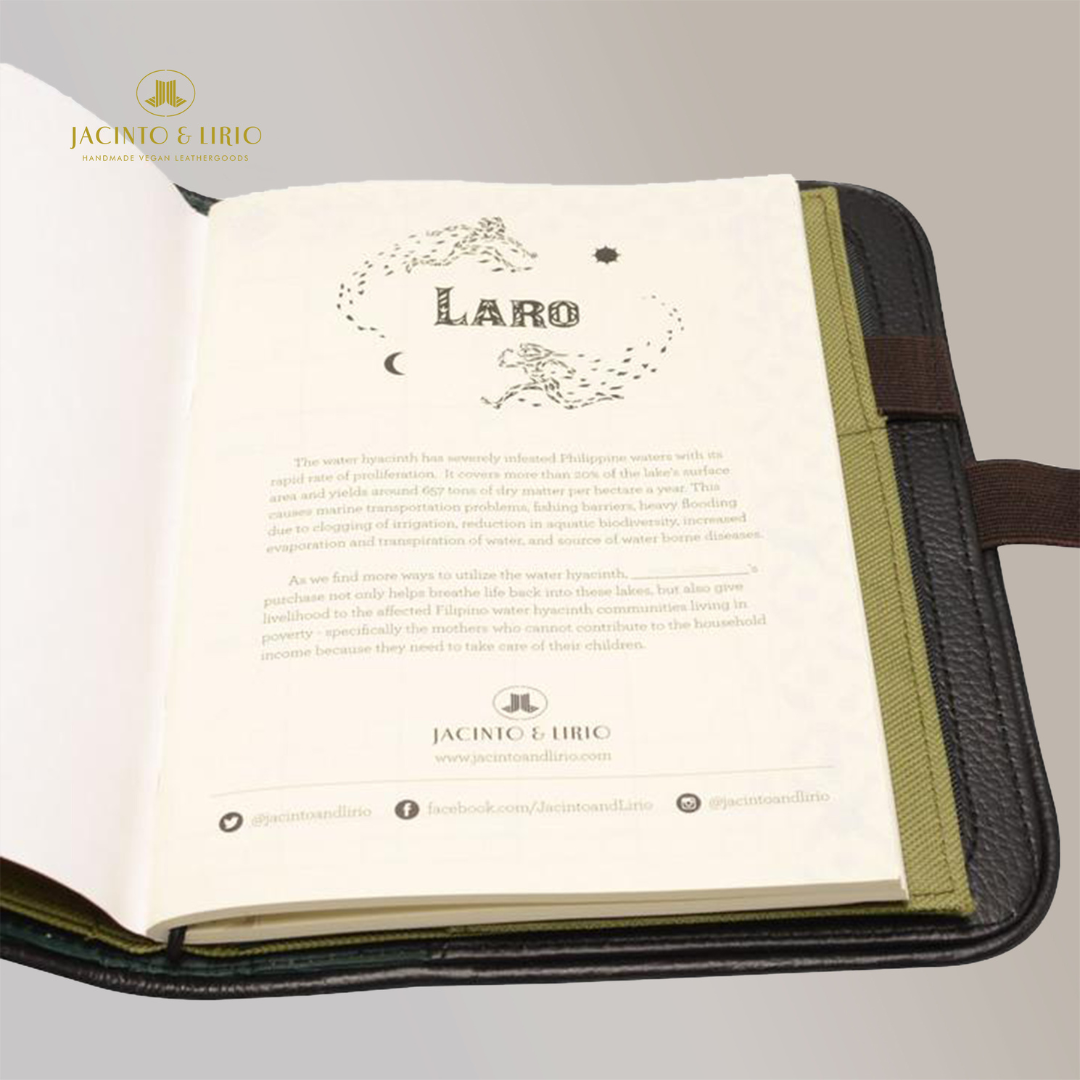 A vegan leather notebook made of green and black leather, opened to its very first page which hosts the product description.
