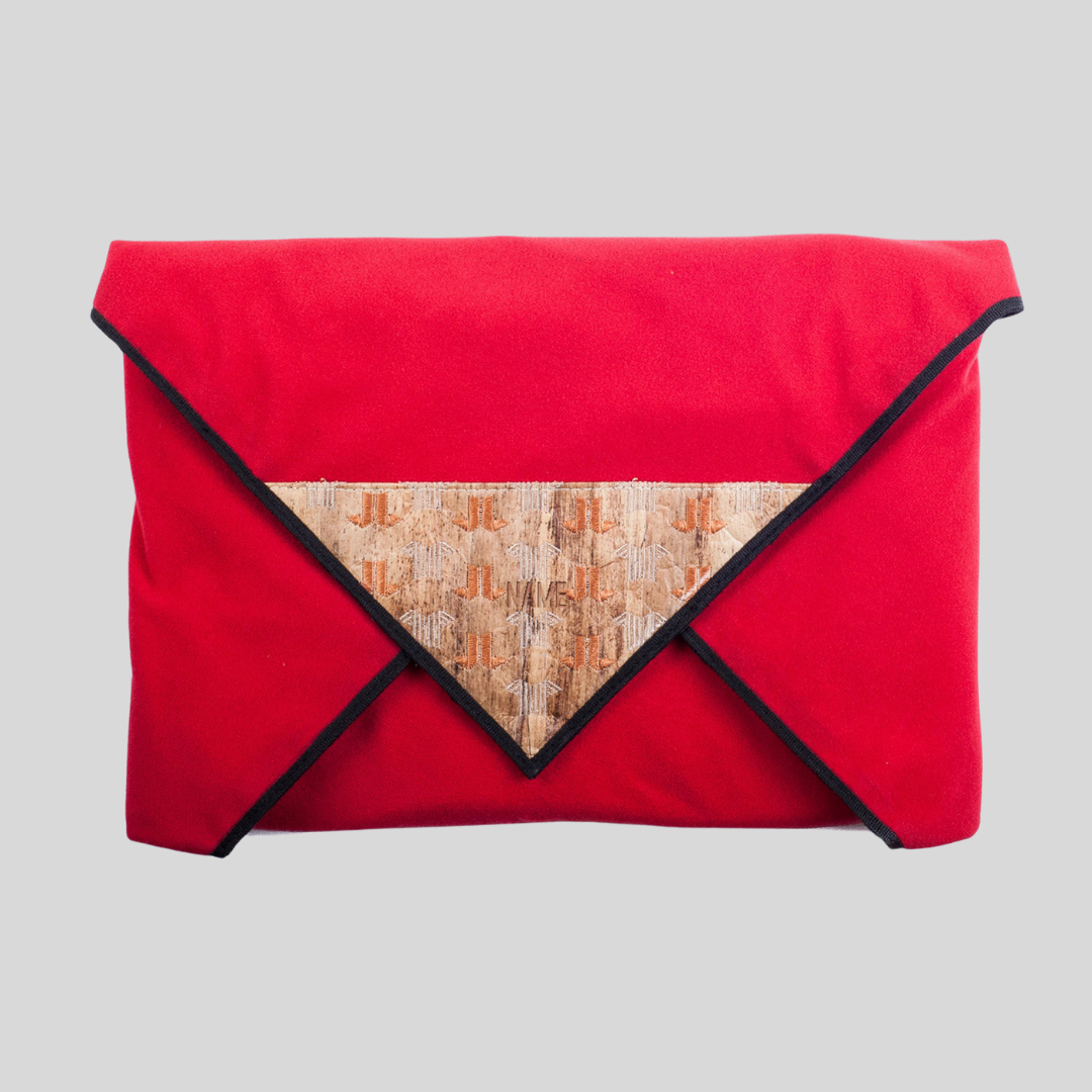 A bright red fabric envelope with a vegan leather tip on its front flap.