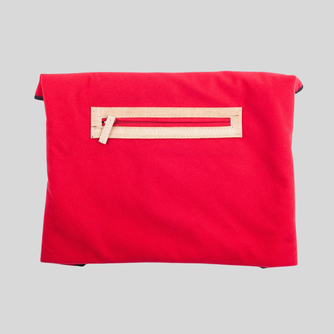 The back of a fabric wrappable envelope that has a discrete zipper compartment.
