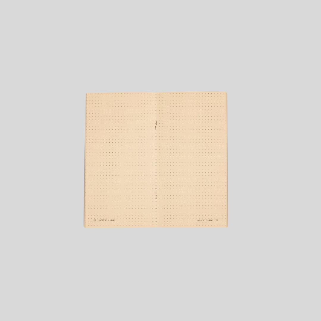 A cream-paged dotted notebook that is laid open.