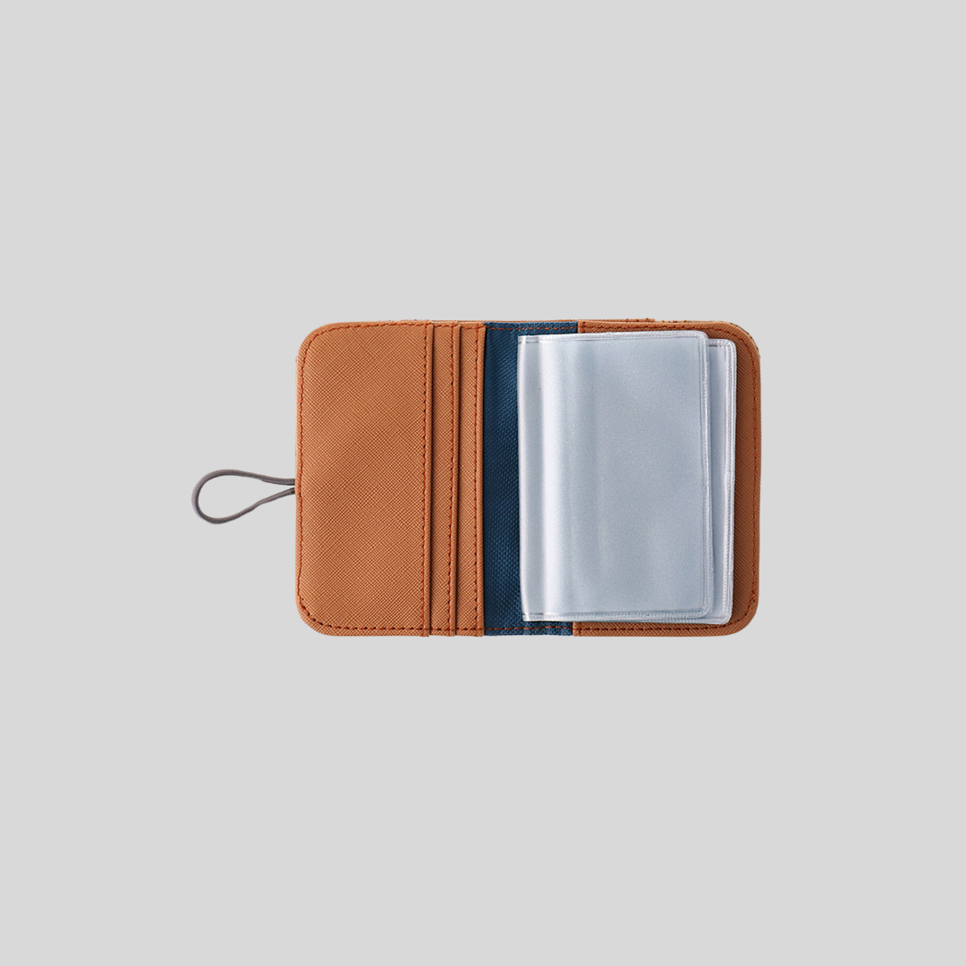 An opened brown vegan leather card wallet with clear plastic card insert pockets.