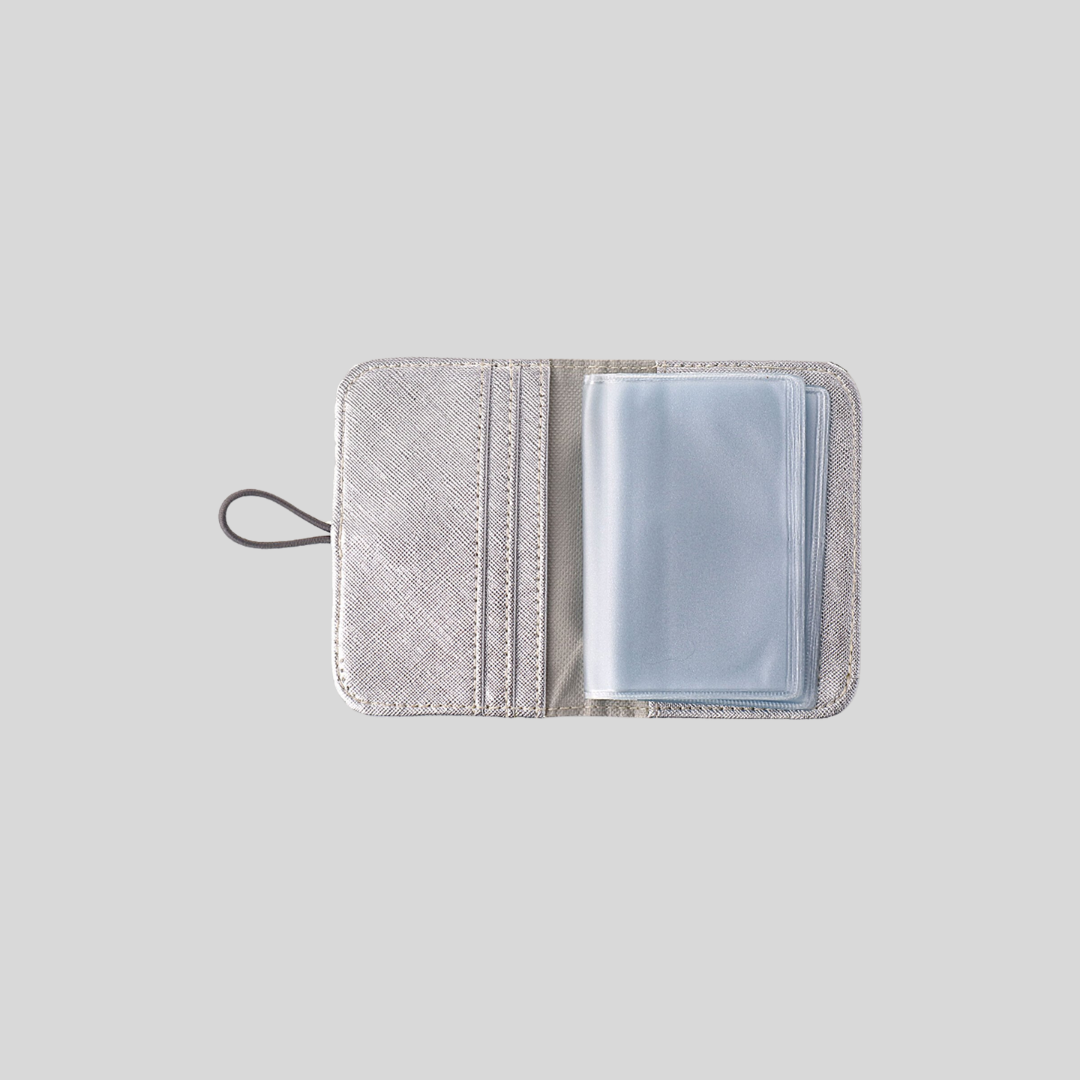 A silver vegan leather card wallet and its clear plastic pages.