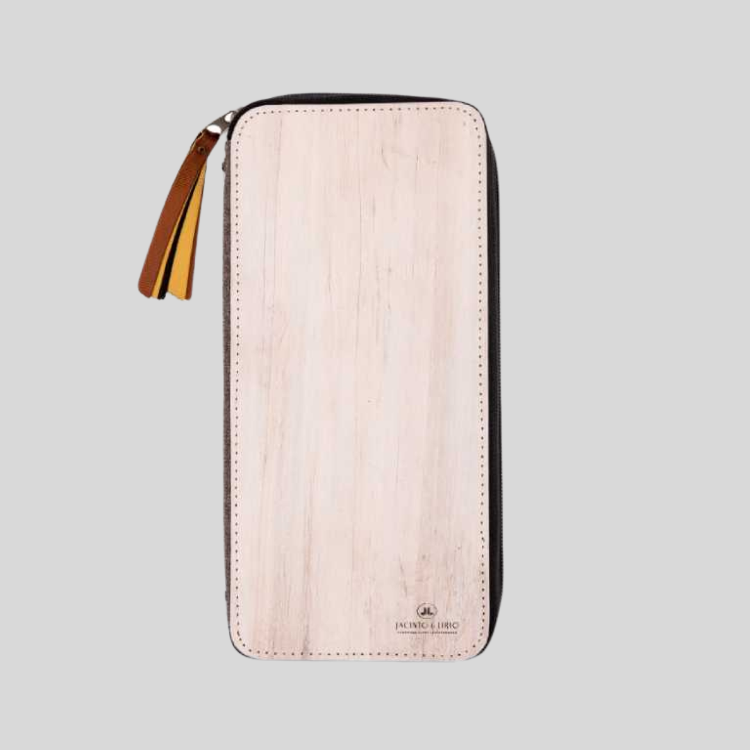 A pale birch-colored vegan leather wallet that has a brown leather tassel on the corner.