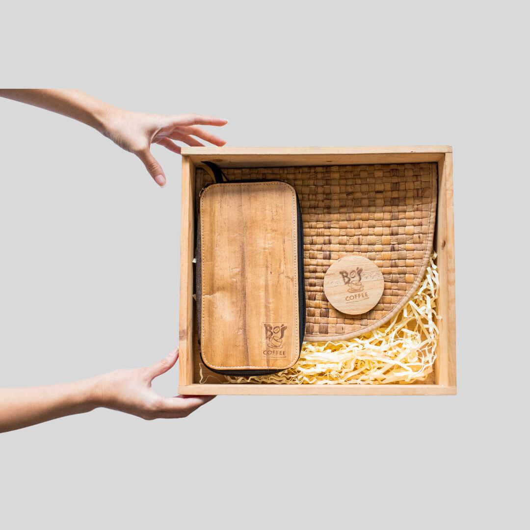 A wooden crate box containing a vegan leather wallet with Bo's Coffee logo engraved on it.