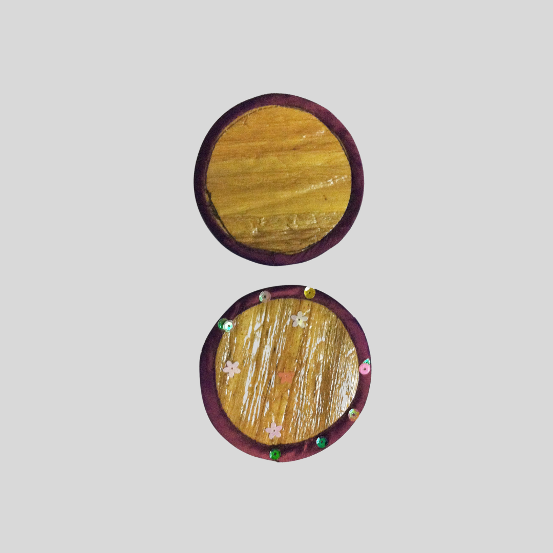 A circular coaster made of vegan leather with a purple velvet hem that can be bedazzled with crystals if desired.