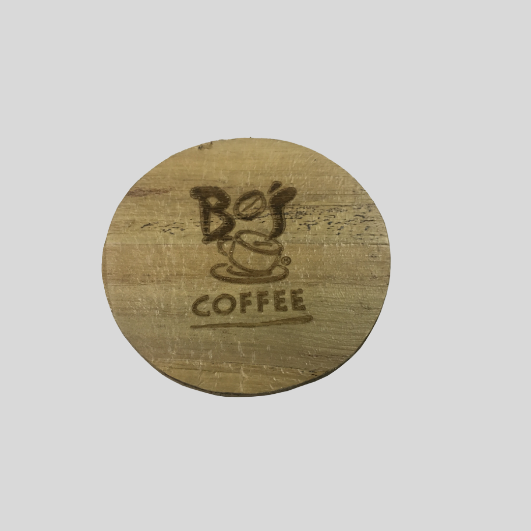 A circular coaster with Bo's Coffee logo engraved on it.