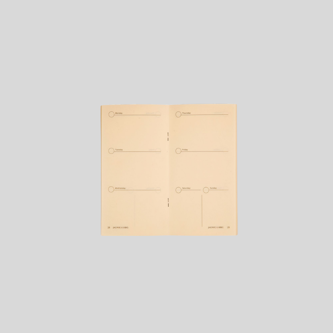 Opened blank notebook refill with cream-colored dated pages.
