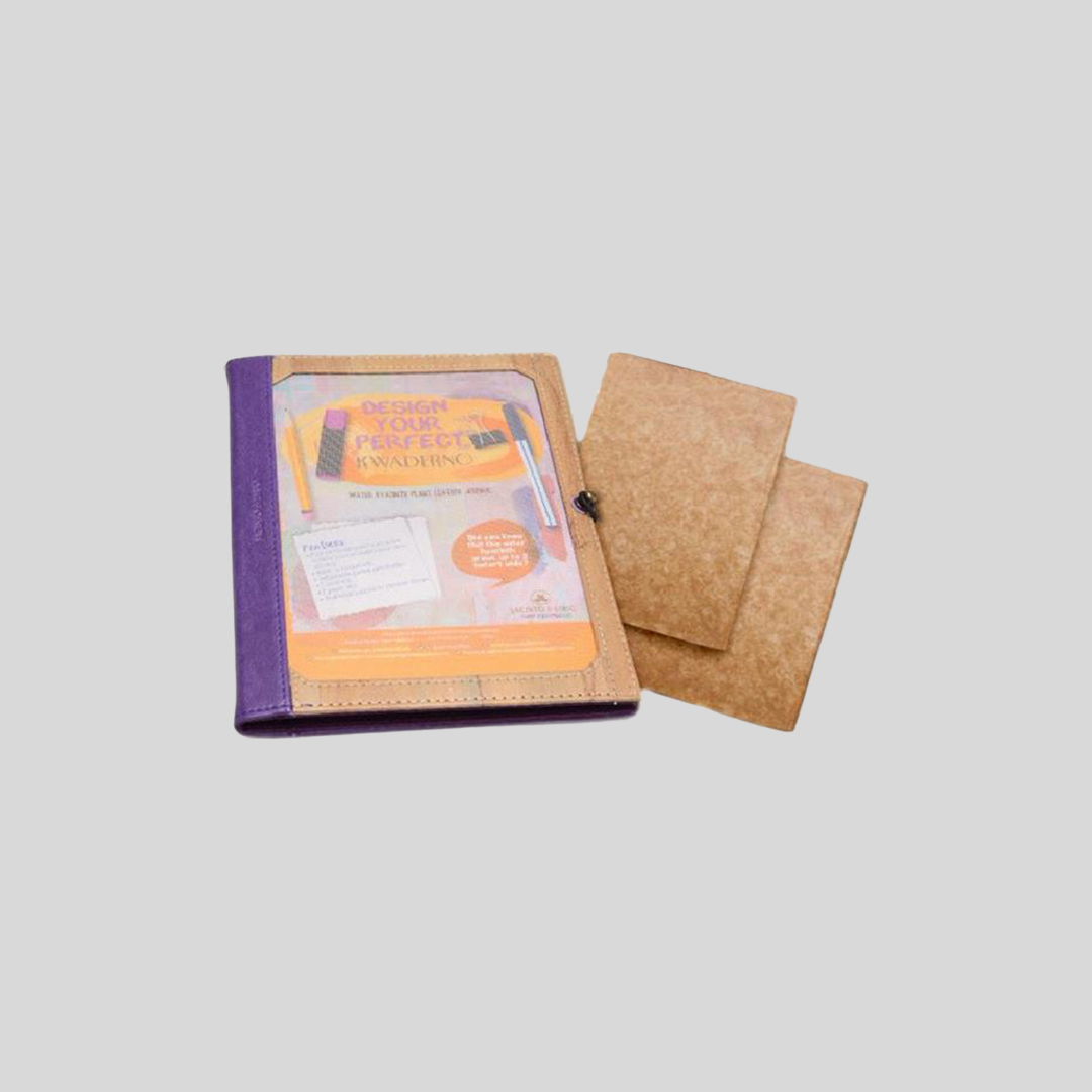 A vegan leather journal with a picture frame cover next to two of its refillable page inserts.