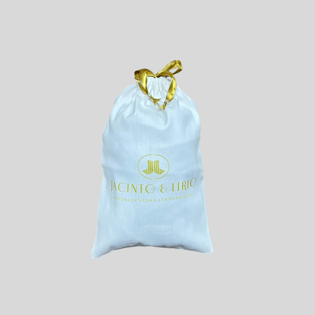 drawstring eco-bag with a white fabric design, gold ribbon closure, and branding for handmade vegan leathergoods.