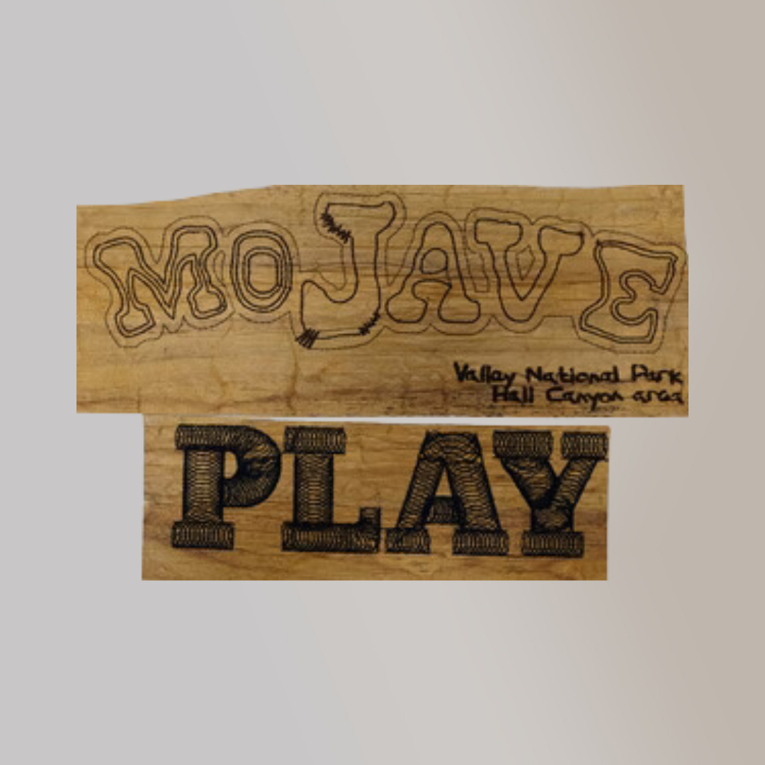 Embroidered words "Mojave" and "PLAY" in black thread on surfaces of water hyacinth vegan leather.