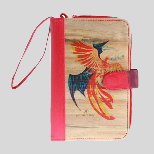 A vegan leather notebook with a bright pink spine and magnetic closure adorning a colorful hand-drawn image of an Ibong Adarna or Phoenix on its cover.