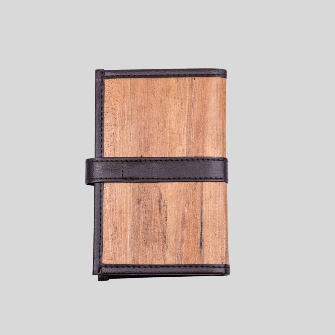 The back of a brown mini vegan leather notebook with a wood like texture and a masculine aesthetic.