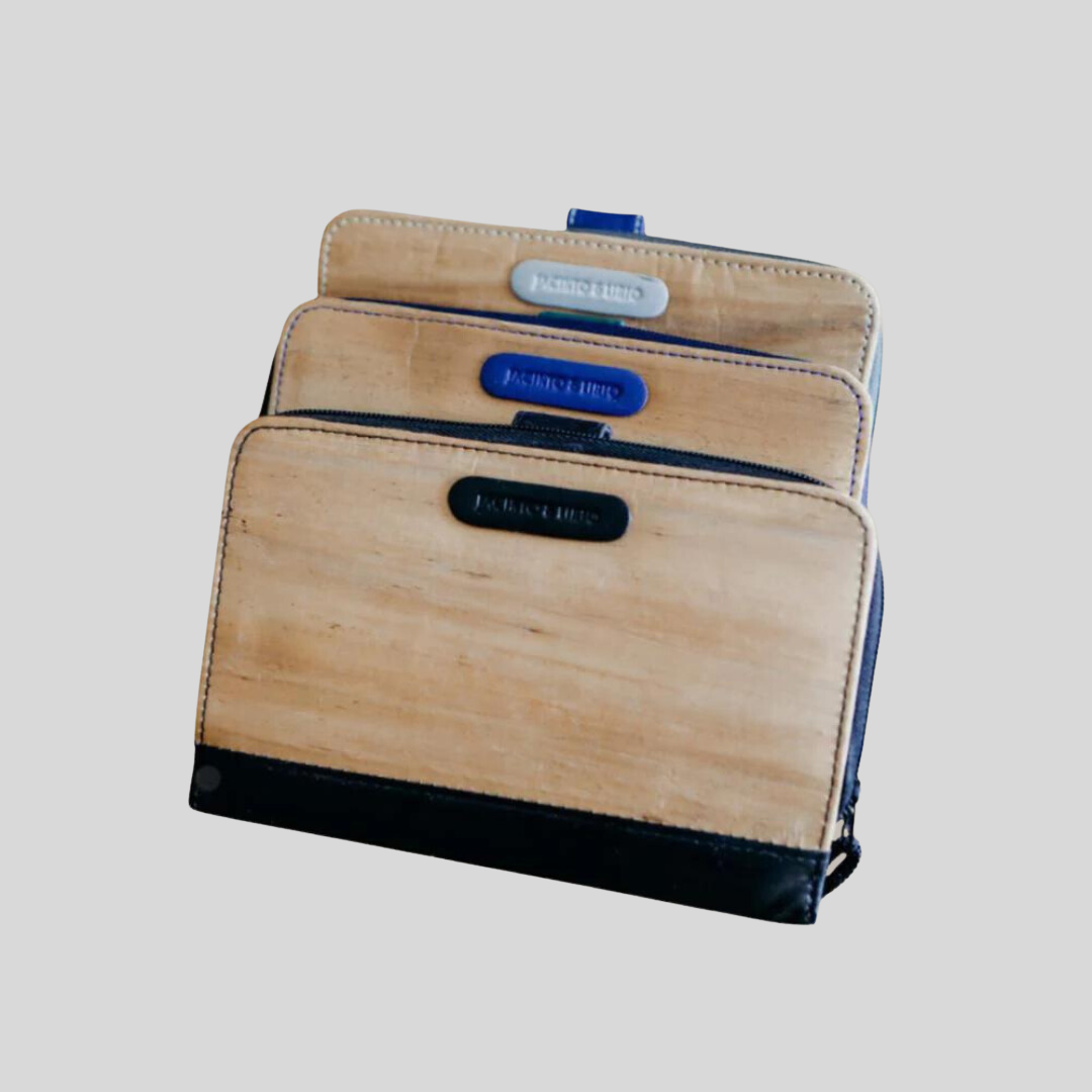 Vegan leather purses with dry embossed names on a leather tab on the upper center of one side.