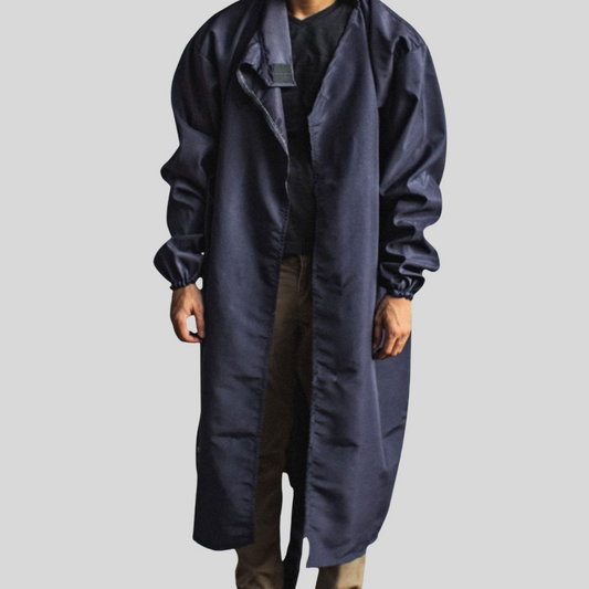 A navy blue microfiber protective suit worn in a open-robe style by a man.