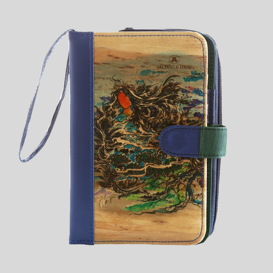A vegan leather notebook with an intricate painted design on its cover and a blue leather spine.