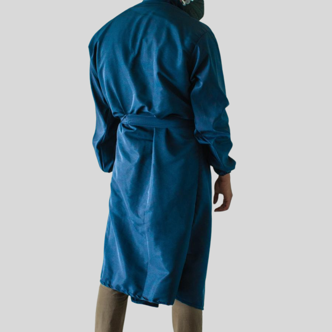 A back view of a person wearing a royal blue colored micro fiber protective suit.