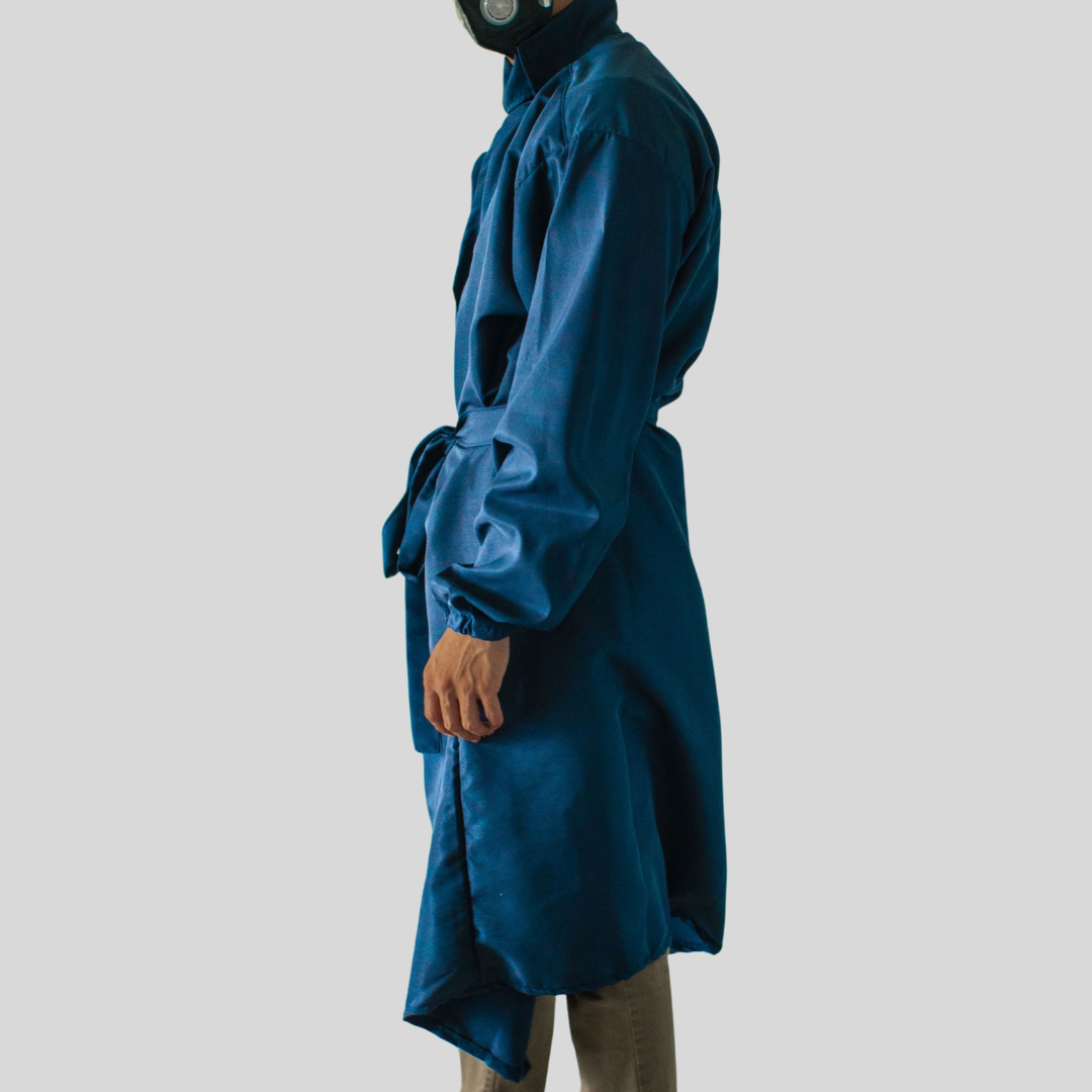 The side view of a model wearing an ocean blue microfiber coat that is tied closed at the front.