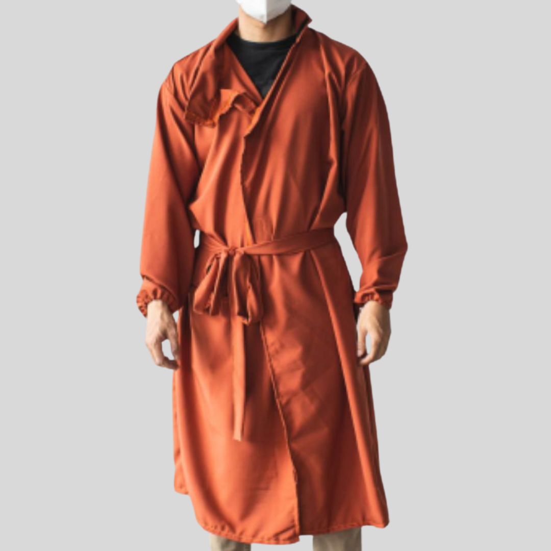 A man wearing an orange protective suit that looks like an overcoat, with its full sleeves and deep v-neck collar.