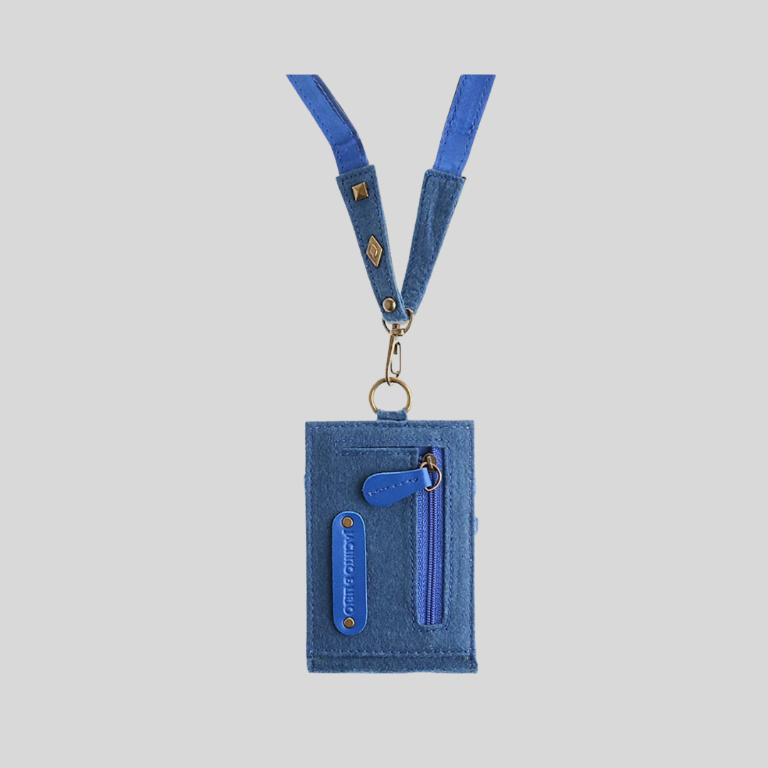 The back side of a blue vegan leather ID lanyard, showing a mini zipped wallet embedded in the lanyard and a logo tag.