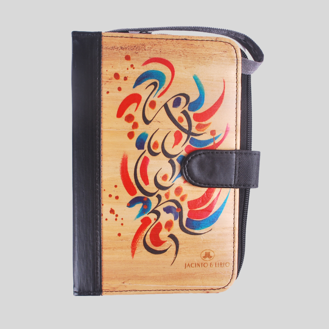 Vegan leather journal with black leather spine and magnetic closure, and painted abstract design on the cover.