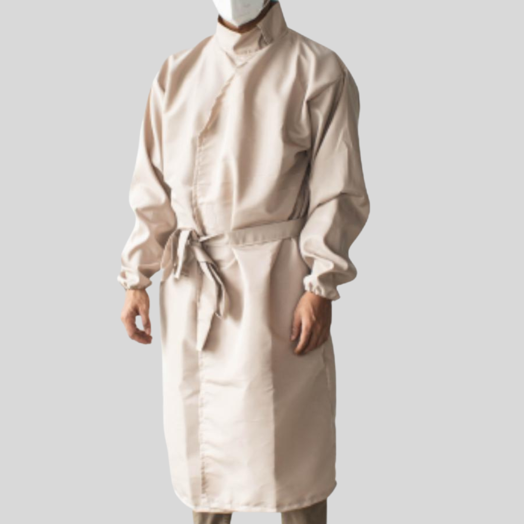 A peach-colored protective suit worn by a man that features a versatile neckline worn as a high-neck and a belt knotted to the side of his waist.