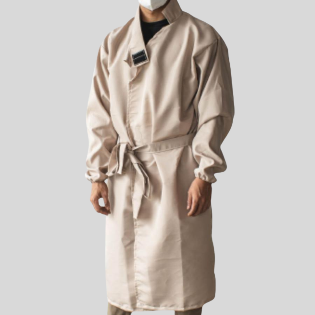 A man wearing a pale pink protective suit made of microfiber that has a versatile neckline worn as a v-neck.