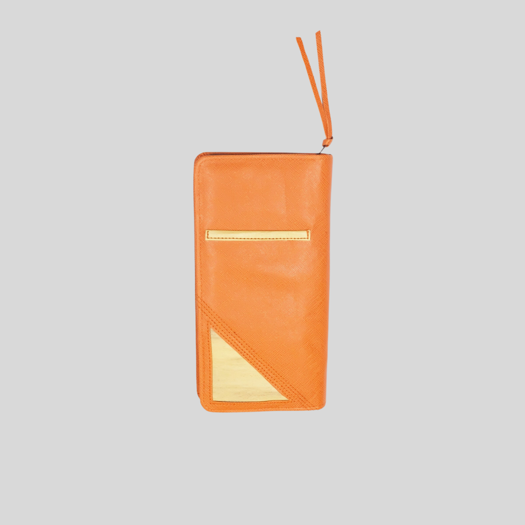 An orange vegan leather purse with a pocket in the back.
