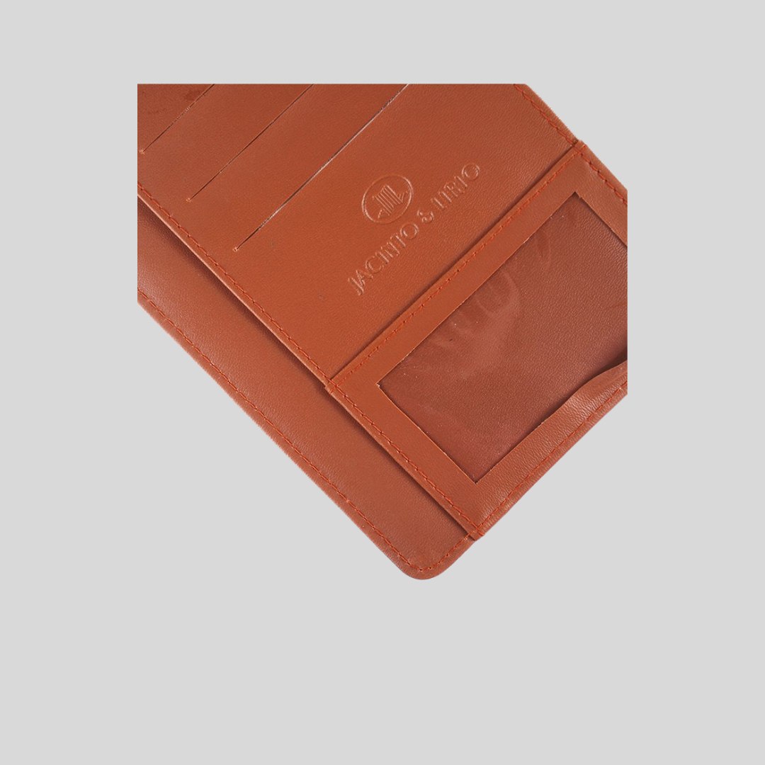 Close up shot of brown leather wallet with mesh cut-out section, card slots, and Jacinto & Lirio company logo engraved in the middle.