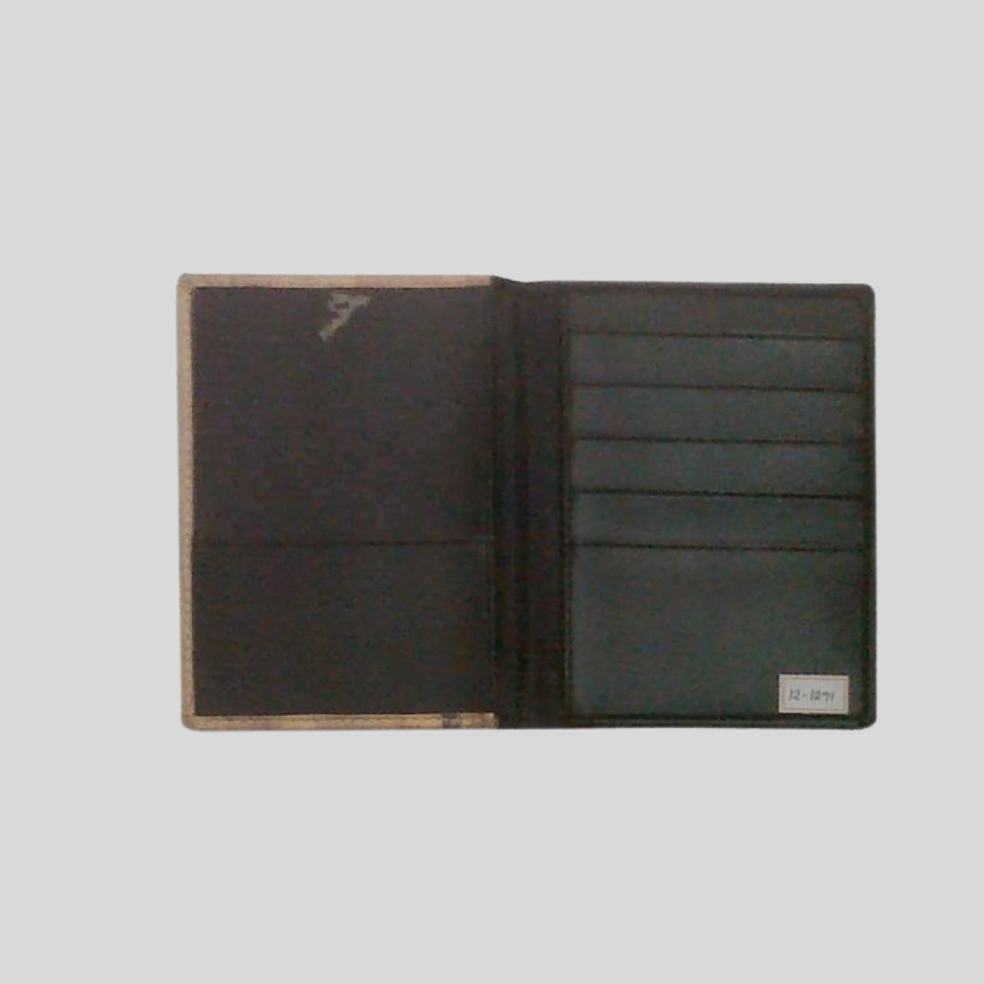 The inside of a black vegan leather iPad case that contains pocket flaps for storage of various things inside