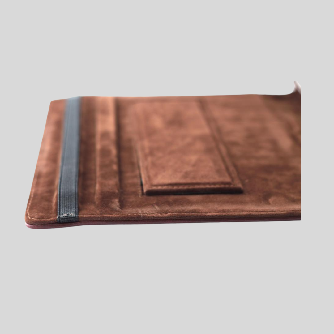 Brown suede interior of an ipad case with a garter closure.