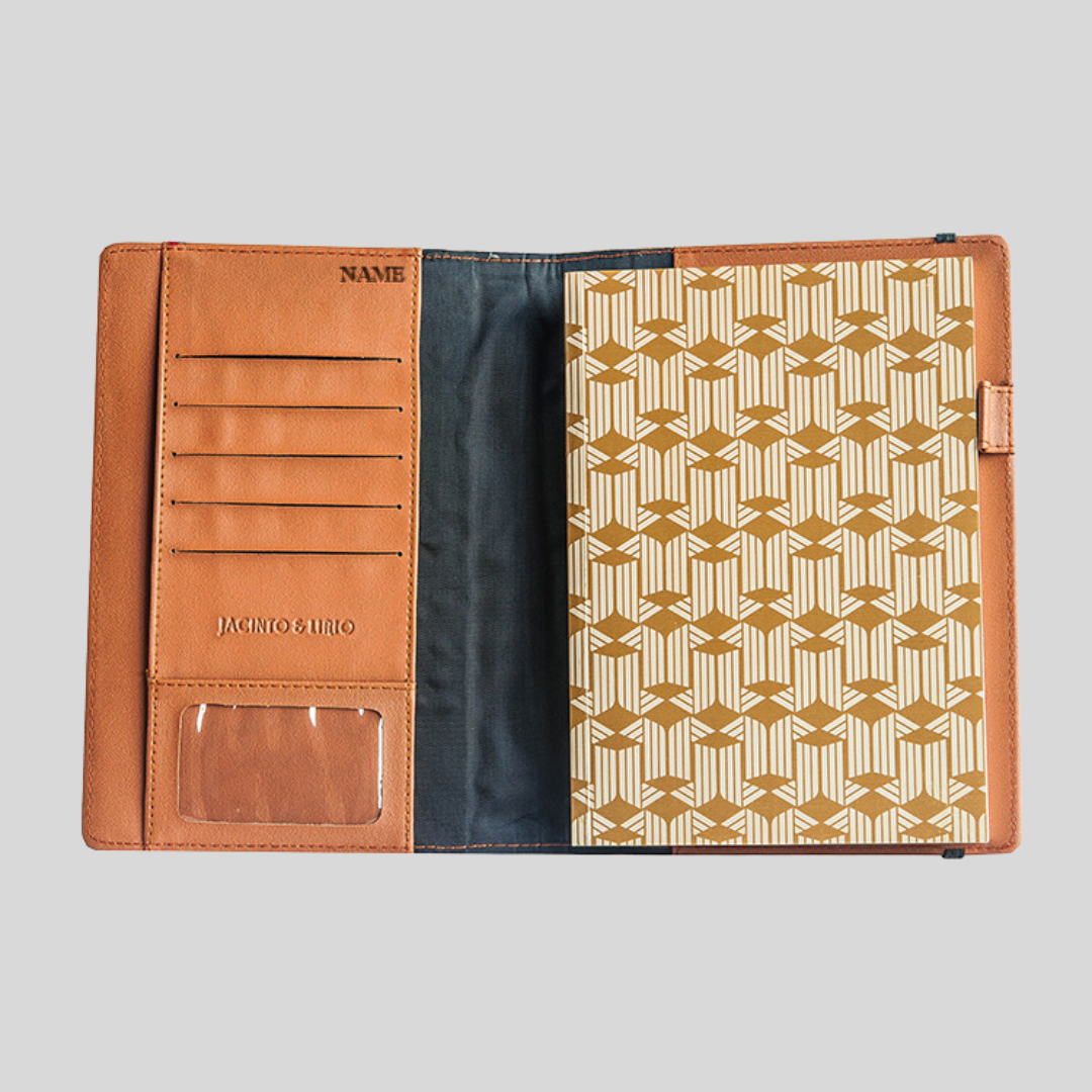 Brown leather notebook laying open, showing card slots, cut-out section for picutures, and name engravement on the inner side of the front cover.