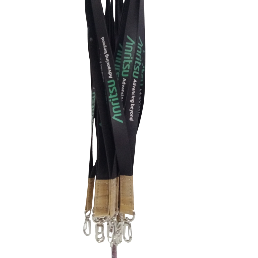 Bulk custom Anritsu lanyards in black with green logo, ideal for corporate events, trade shows, and promotional giveaways. Features durable metal attachments. Featuring the green "Advancing Beyond" slogan, light brown faux vegan leather accents, and silver swivel clips.
