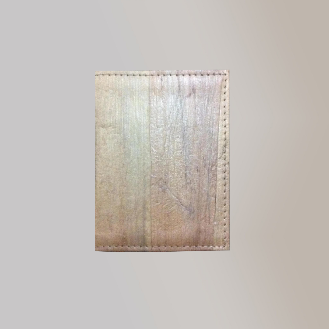 A pale white vegan leather keycard holder with a wood-looking surface due to the water hyacinth vegan leather.