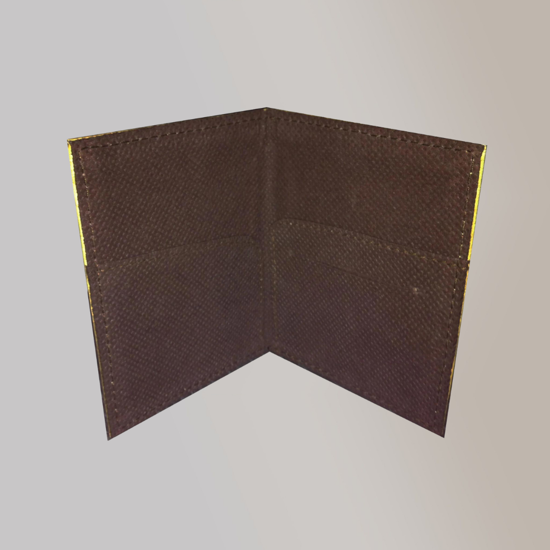 A birds eye view of an upright, slightly opened brown keycard holder for hotel keycards.