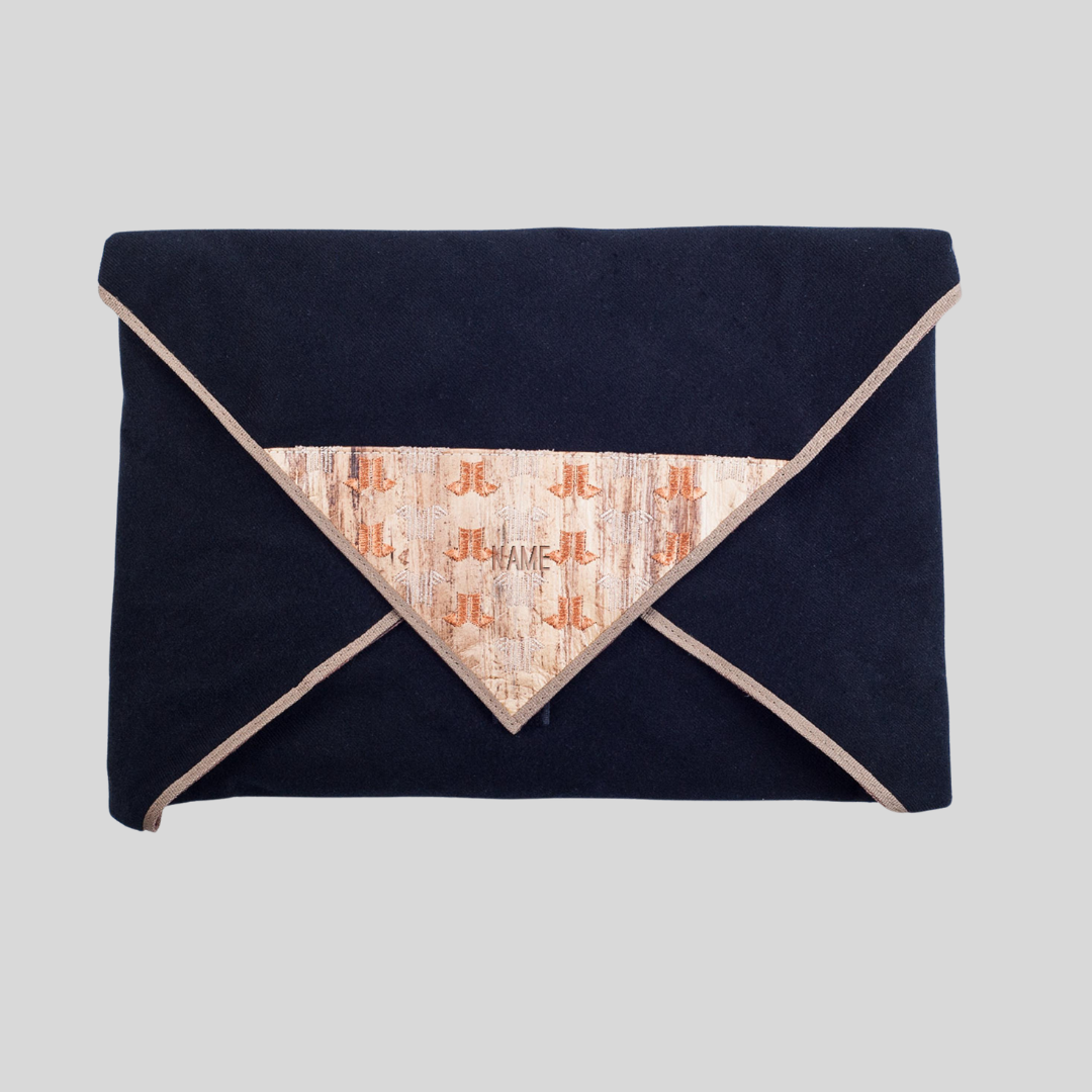 Top view of a laptop wrap from Jacinto & Lirio with a vegan leather front flap tip, J&L logo, name engravement, and body made out of blue fabric.