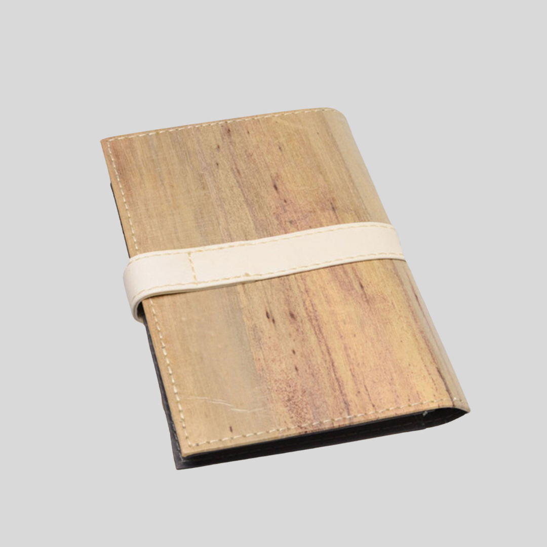 Minimalist notebook made out of vegan leather and a strip of white leather going around the notebook horizontally.