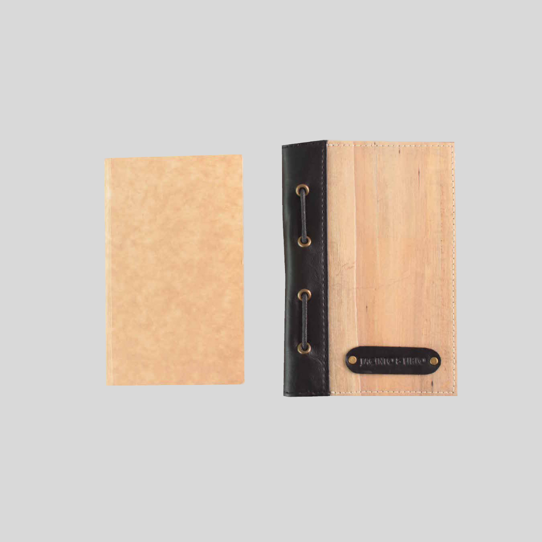 A vegan leather journal cover laid next to its removable page refill.