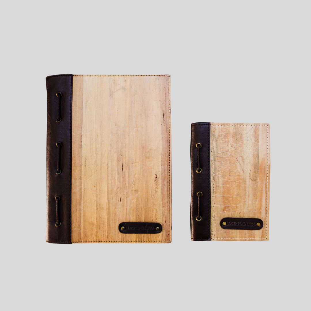 Two sizes of the same vegan leather journal with a dark brown leather spine; one in a bigger size and the other smaller.