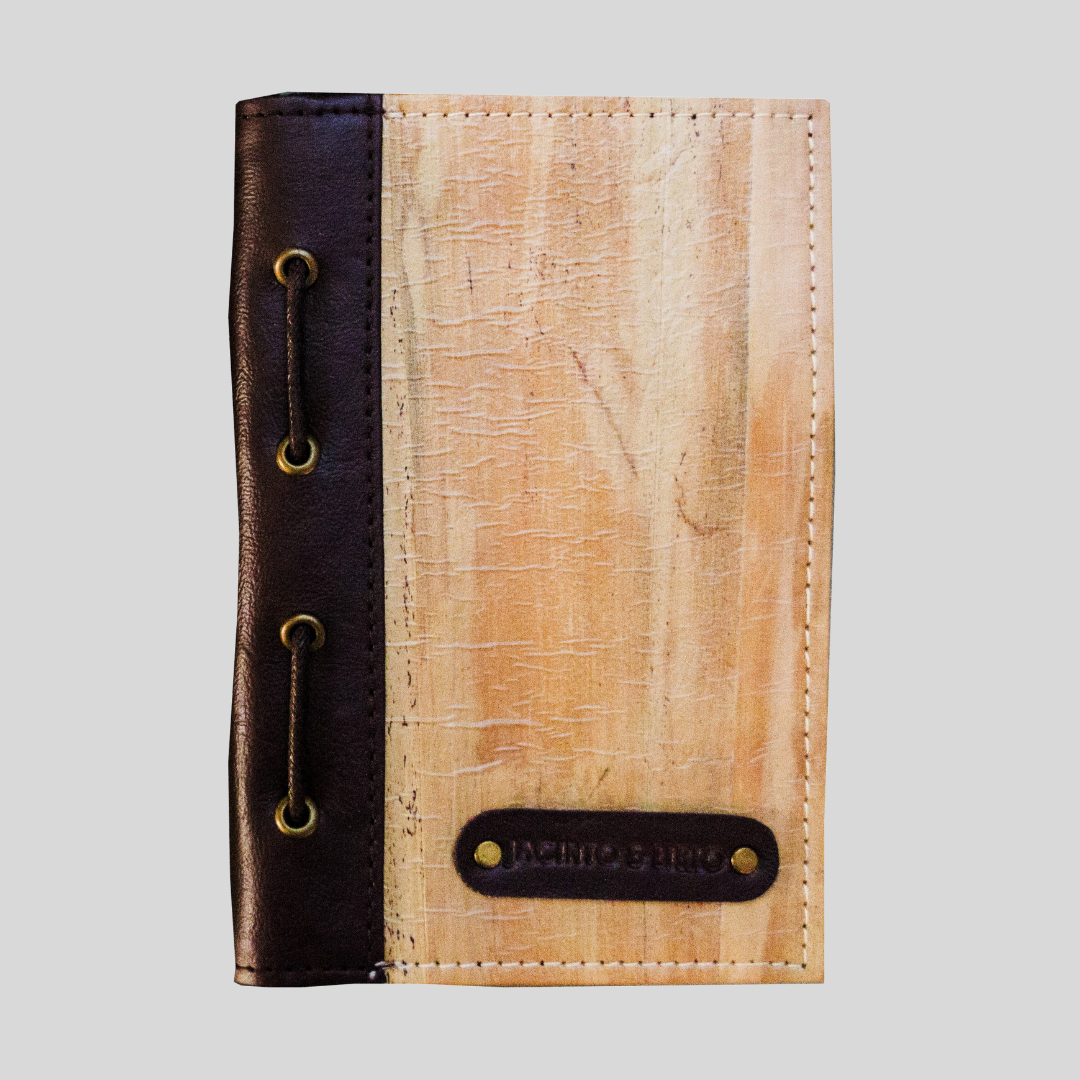 A textured vegan leather notebook with a dark brown leather spine
