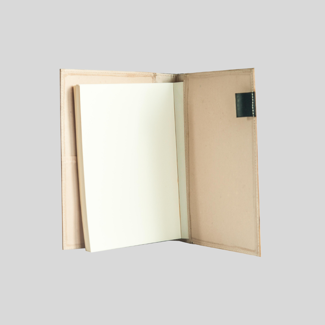 The inside flap of a sand-colored notebook